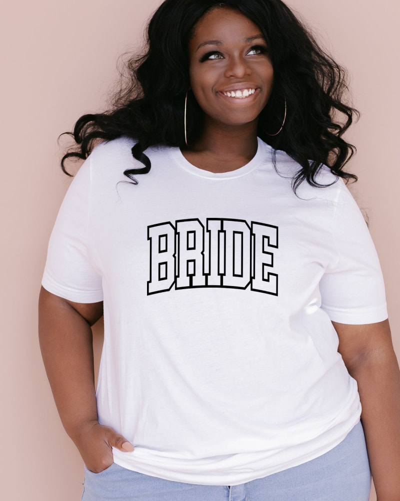 Front of a model wearing a size XL Varsity Bride in White by Simply Sage Market. | dia_product_style_image_id:281456